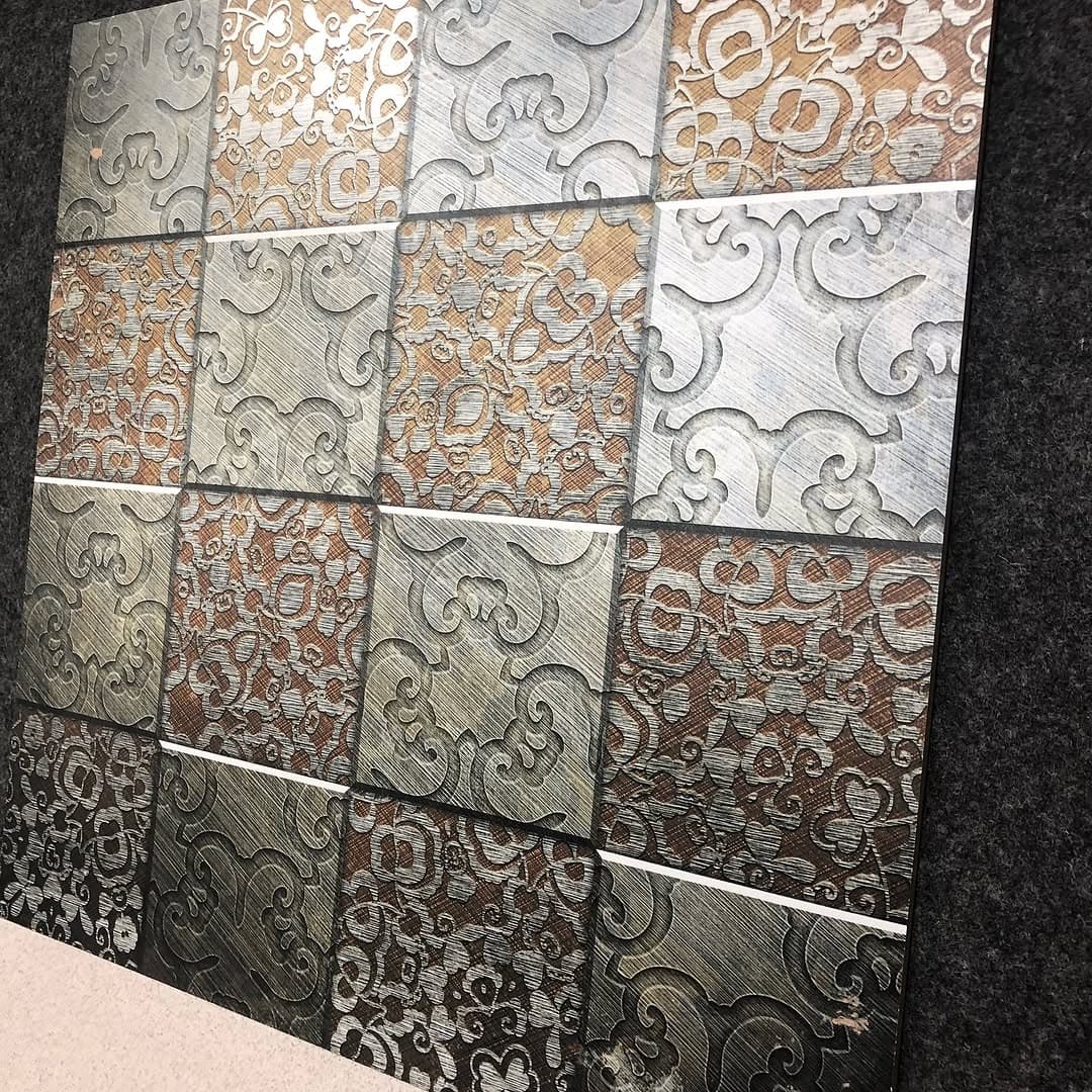 Embossed metallic pattern tiles on the showroom display wall